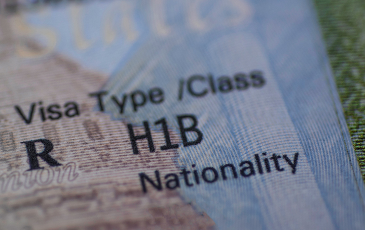 Close-up of an H-1B visa inside a US passport, symbolising the new $100,000 fee in 2025 and its impact on tech hiring and international recruitment.