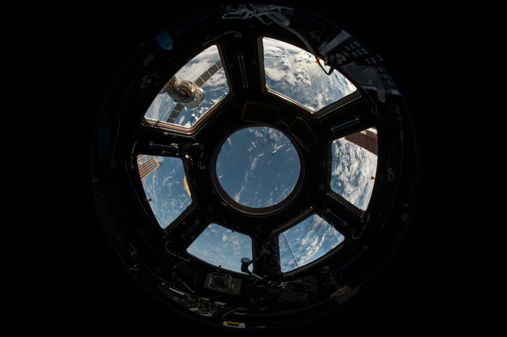 A view of earth from the inside of a spacecraft